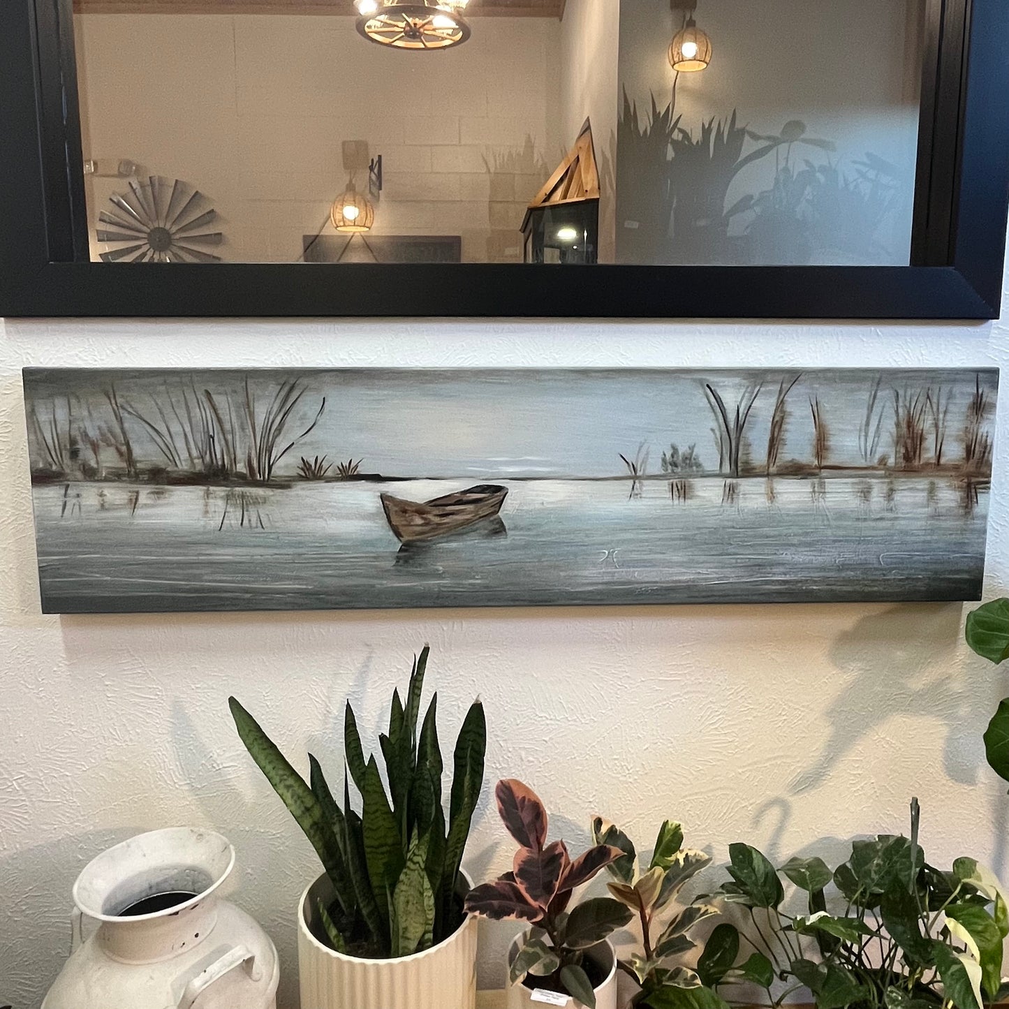Decorative painting of a boat on water with plants below
